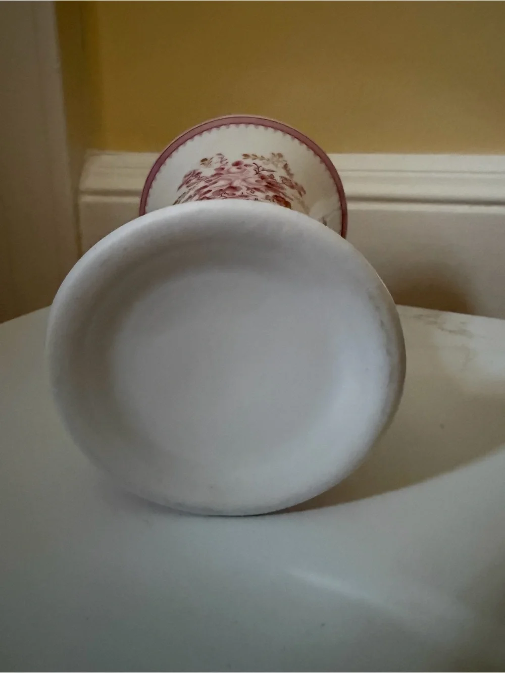 A vintage fluted vase w raspberry floral motif.